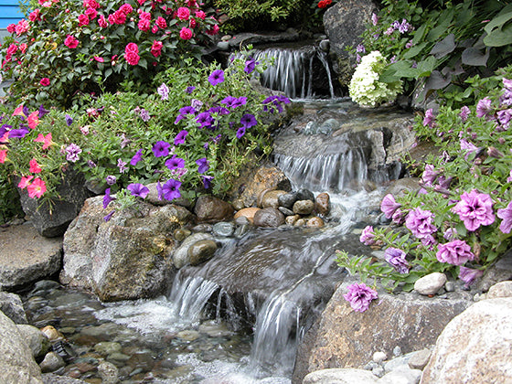 Beautiful three step pondless waterfalls and stream cascading through colorful flowers - created by Russell Watergardens
