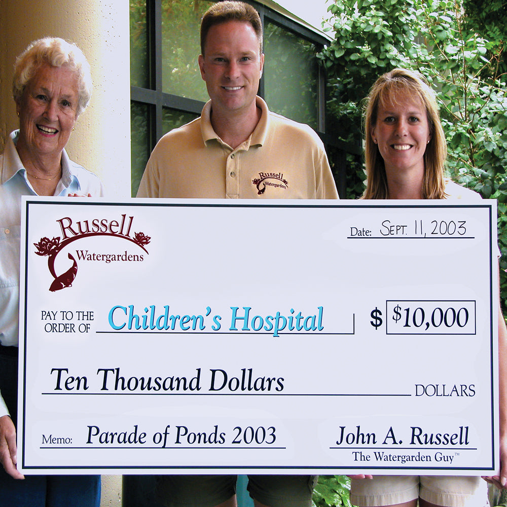John and Pamela Russell donating $10,000 dollars to Children's Hospital on September 11, 2003