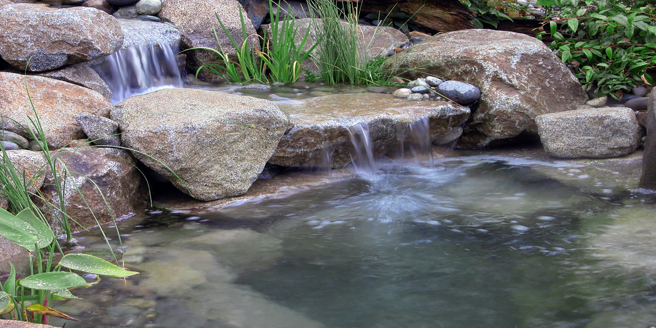 Beautiful clean waterfalls and pond by using HydroClear pond water treatments from Russell Watergardens
