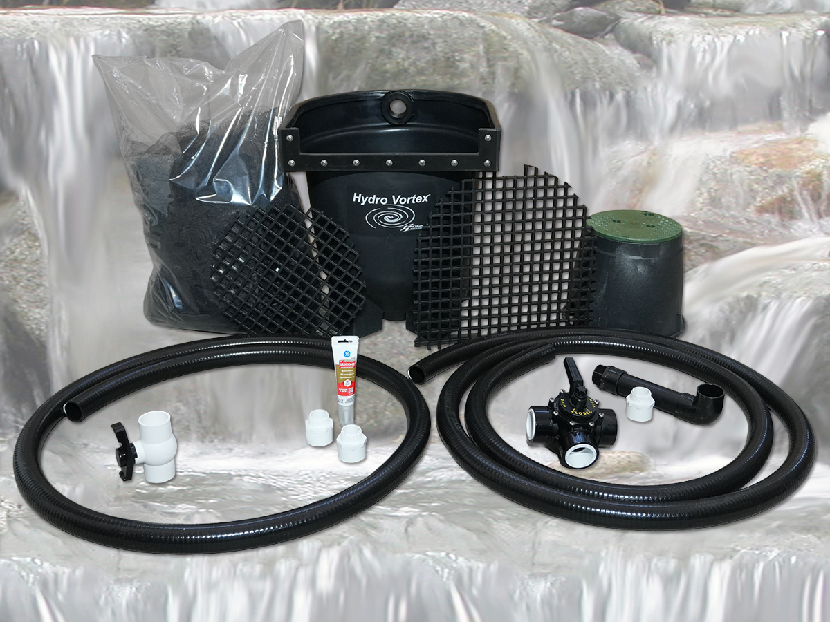 Hydro Vortex 300 fish pond filtration kit with black mesh screens, black corrugated tubing, white fittings, and a green filter canister, displayed against a backdrop of white waterfall rocks.